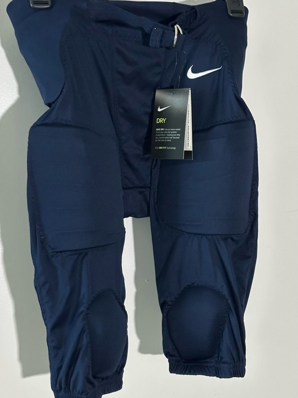 Nike DRI FIT Navy Blue PADDED FOOTBALL PANTS built in padding for protection.